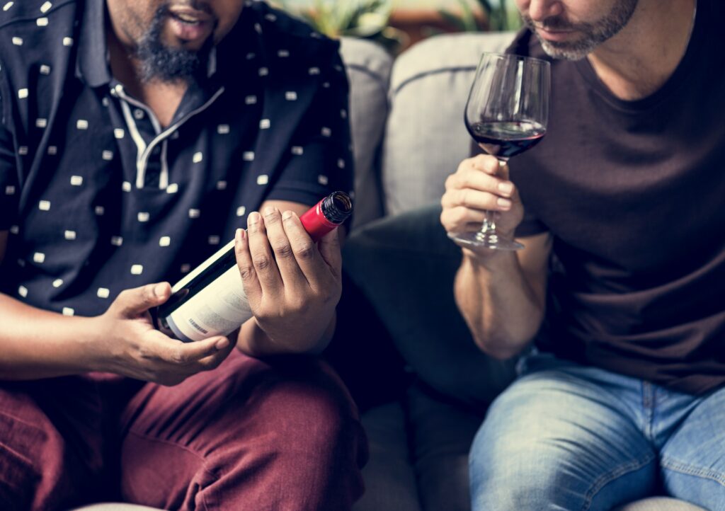 Man tasting red wine with friends